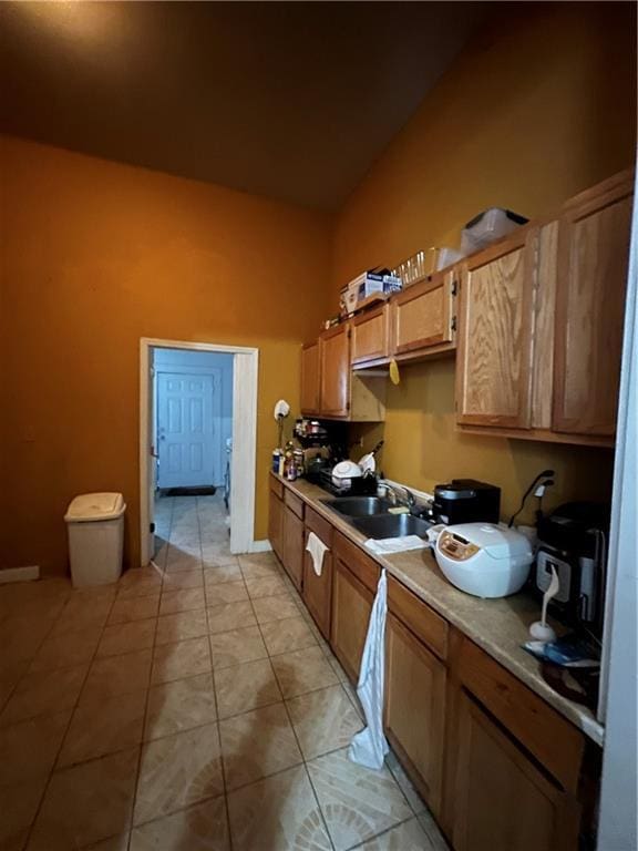 kitchen featuring light tile patterned floors and sink