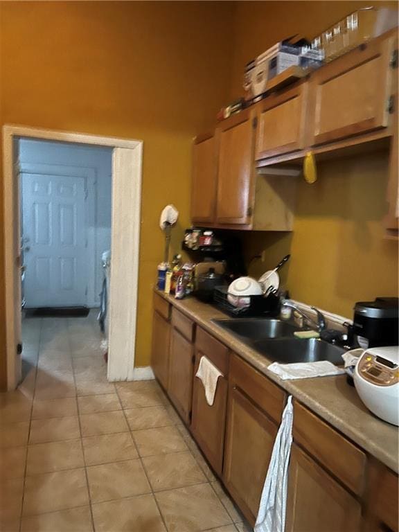 kitchen featuring light tile patterned floors and sink