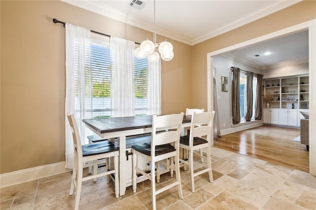 dining area featuring a chandelier, light wood-type flooring, a wealth of natural light, and ornamental molding