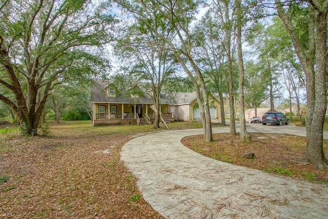 view of front facade featuring a porch and a garage