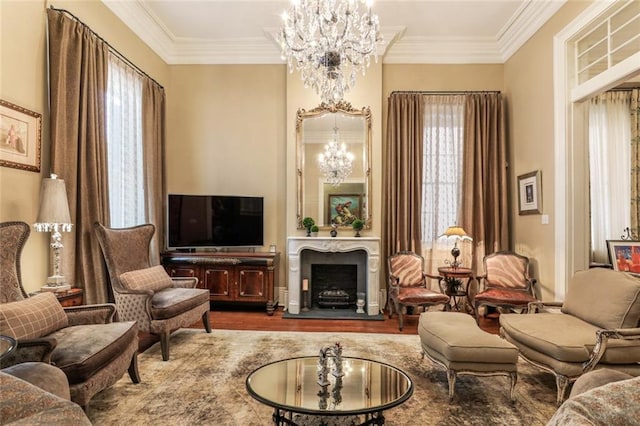 sitting room with crown molding, wood-type flooring, and an inviting chandelier