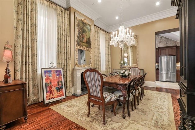 dining room with dark hardwood / wood-style flooring, a chandelier, and ornamental molding