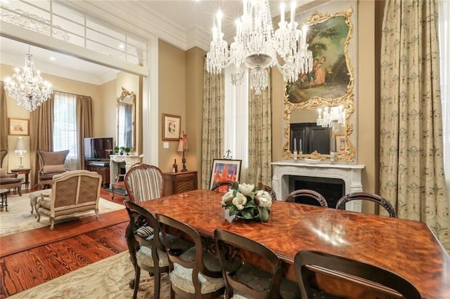 dining area with crown molding, hardwood / wood-style floors, and a notable chandelier