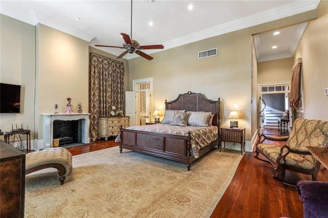 bedroom featuring ceiling fan, ornamental molding, and hardwood / wood-style flooring