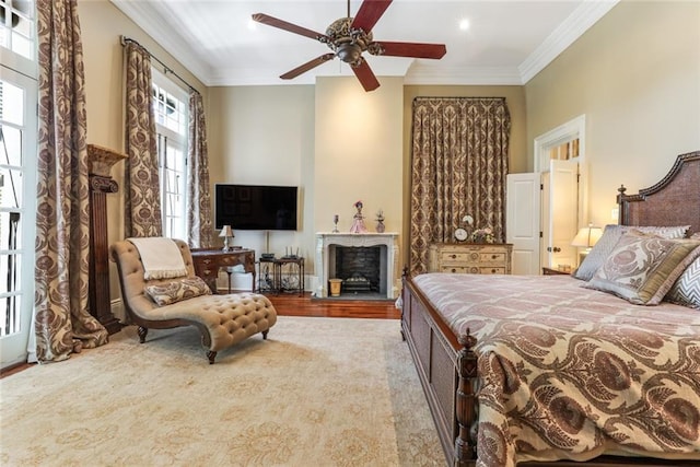 bedroom with ceiling fan, light wood-type flooring, and ornamental molding