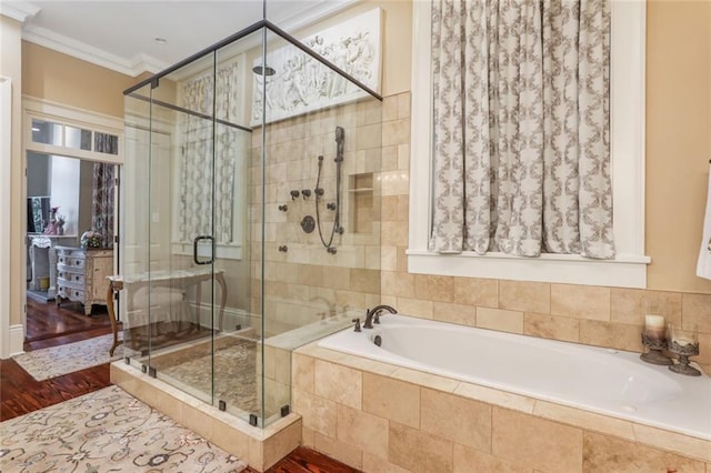 bathroom featuring wood-type flooring, shower with separate bathtub, and ornamental molding