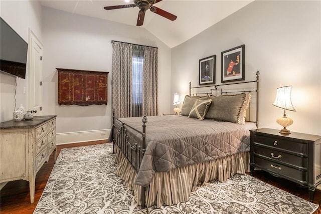 bedroom featuring hardwood / wood-style floors, vaulted ceiling, and ceiling fan