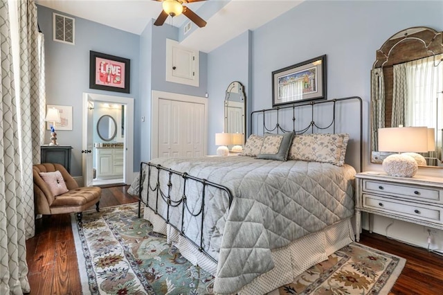 bedroom featuring dark hardwood / wood-style flooring, a closet, ceiling fan, and connected bathroom