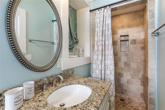 bathroom with curtained shower and vanity