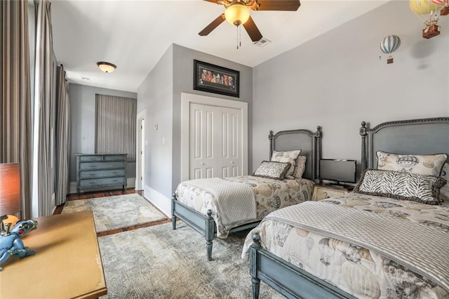 bedroom featuring ceiling fan, lofted ceiling, and a closet