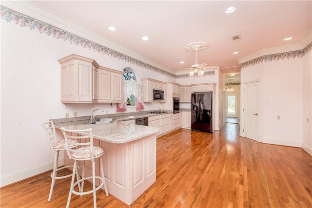 15070 Bruhl Rd, Folsom, LA 70437 - kitchen featuring ceiling fan, light wood-type flooring, a peninsula, black appliances, and a sink