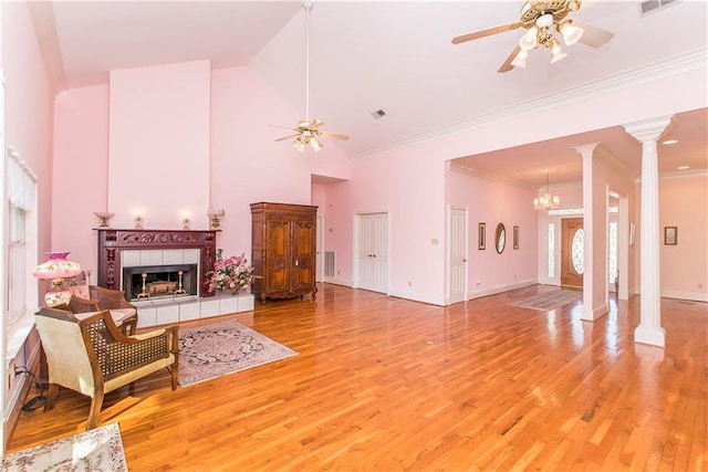 15070 Bruhl Rd, Folsom, LA 70437 - living area with light wood-type flooring, a fireplace, and ceiling fan with notable chandelier