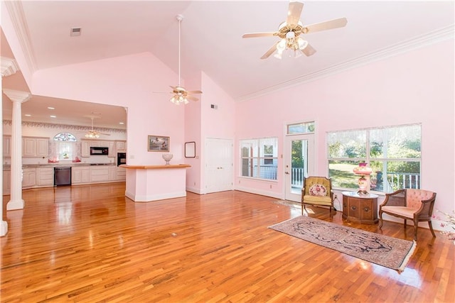 15070 Bruhl Rd, Folsom, LA 70437 - living room featuring light wood finished floors, ceiling fan, ornamental molding, decorative columns, and high vaulted ceiling