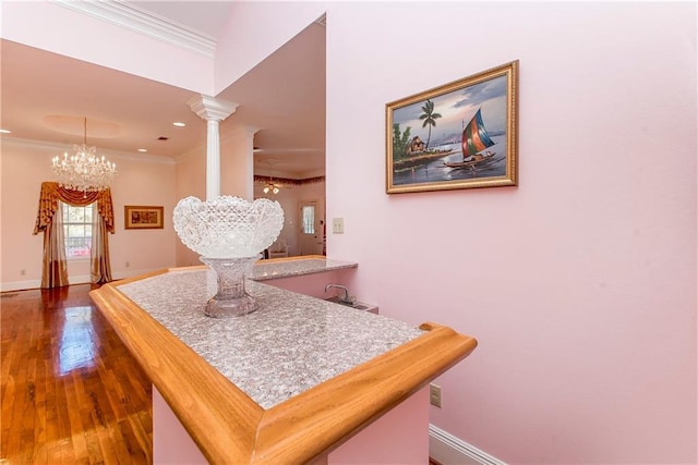 15070 Bruhl Rd, Folsom, LA 70437 - dining space with baseboards, decorative columns, dark wood-style flooring, crown molding, and a chandelier