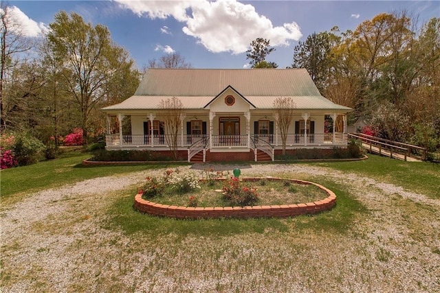 15070 Bruhl Rd, Folsom, LA 70437 - farmhouse with a front yard, covered porch, and metal roof