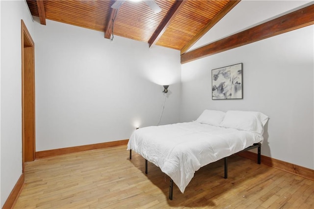 bedroom with vaulted ceiling with beams, light wood-type flooring, ceiling fan, and wood ceiling