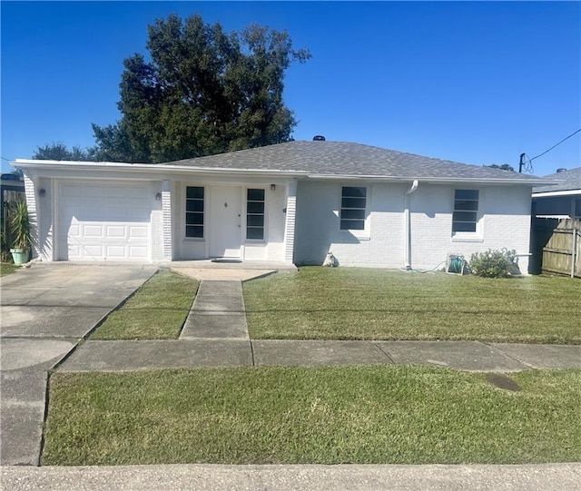 single story home with a front yard and a garage