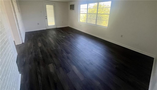 spare room featuring dark hardwood / wood-style floors