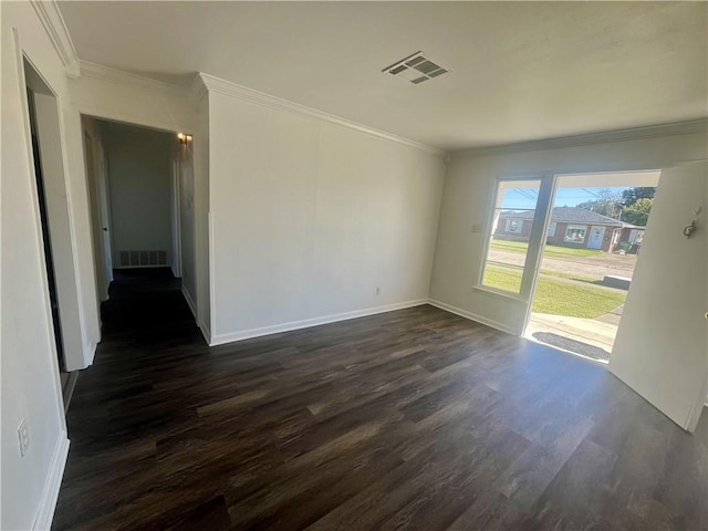 empty room with crown molding and dark hardwood / wood-style flooring