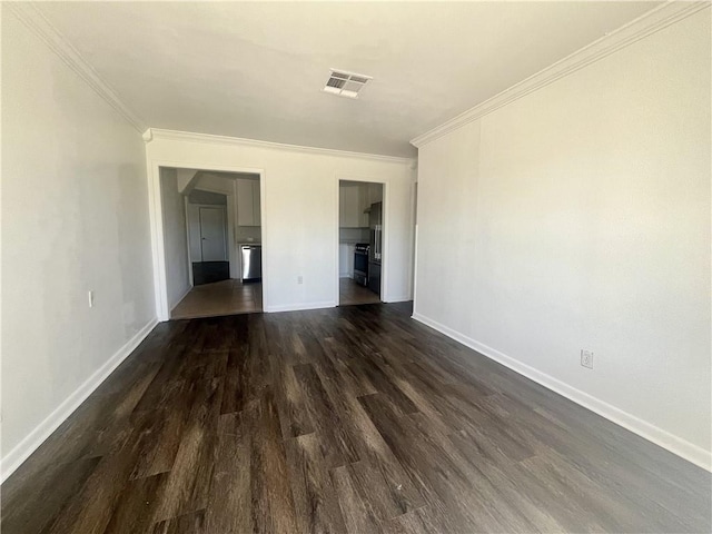 empty room featuring dark wood-type flooring and ornamental molding