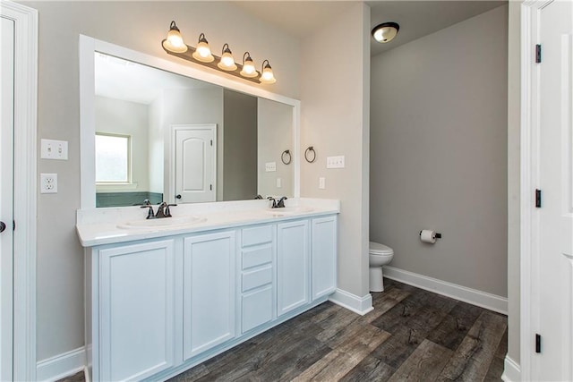 bathroom with vanity, toilet, and wood-type flooring