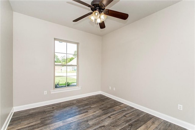 spare room featuring ceiling fan and dark wood-type flooring