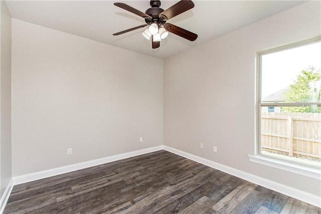 spare room featuring dark hardwood / wood-style flooring and ceiling fan