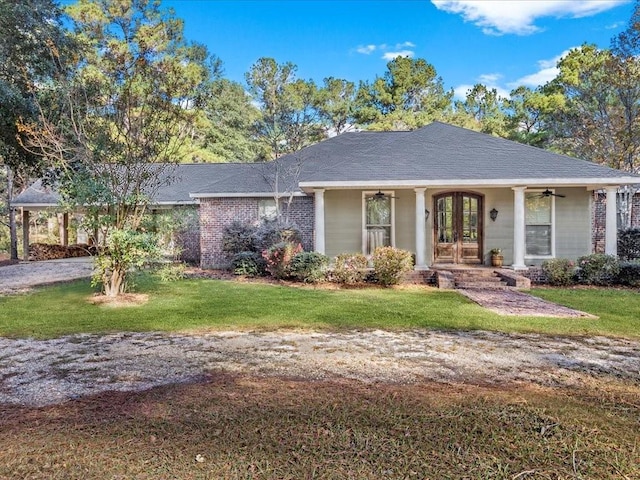 ranch-style house with a front yard, french doors, and ceiling fan