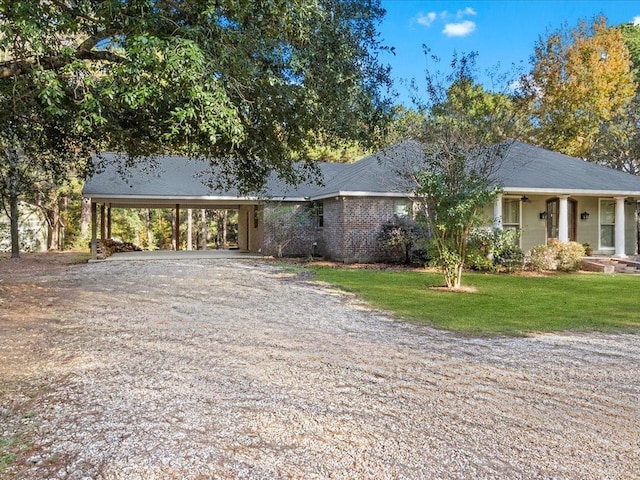 single story home with a front lawn and a carport