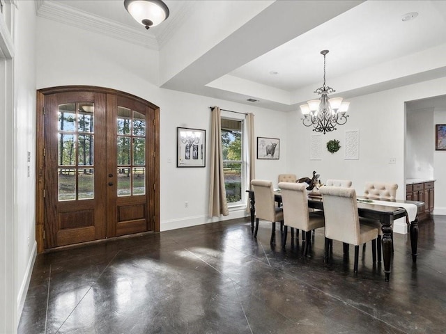 dining space with a notable chandelier, crown molding, a tray ceiling, and french doors