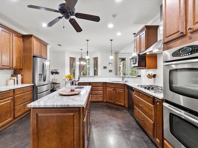 kitchen with a center island, backsplash, sink, hanging light fixtures, and appliances with stainless steel finishes