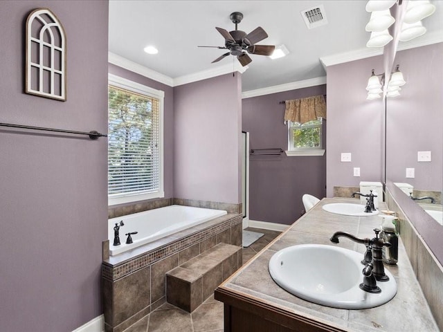 bathroom featuring tiled tub, a wealth of natural light, vanity, and ornamental molding