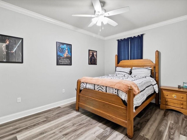 bedroom featuring hardwood / wood-style flooring, ceiling fan, and crown molding