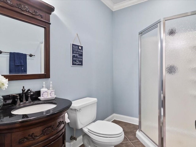 bathroom featuring vanity, tile patterned floors, crown molding, toilet, and an enclosed shower