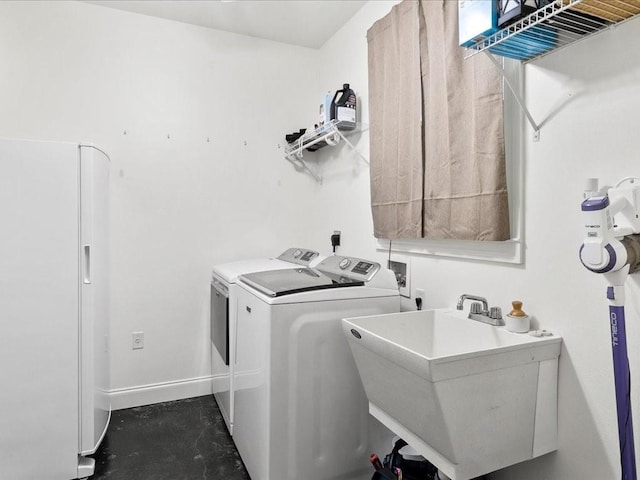 laundry area with washing machine and dryer and sink