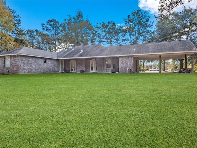 rear view of house with a yard