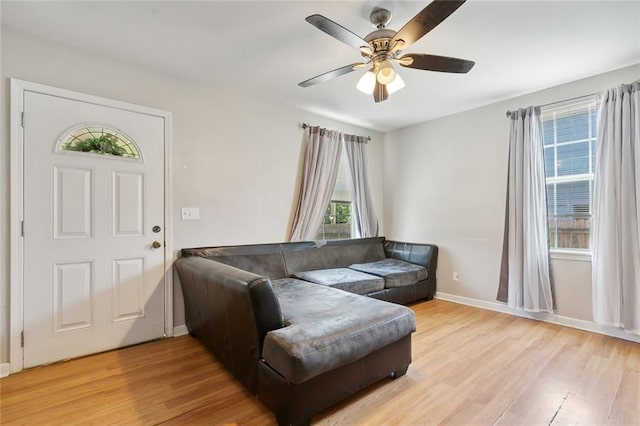 living room with ceiling fan and light hardwood / wood-style floors