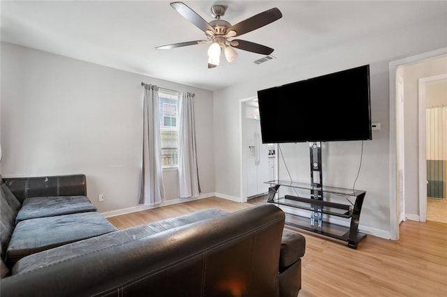 living room featuring hardwood / wood-style floors and ceiling fan