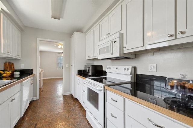 kitchen featuring white appliances, white cabinetry, and ceiling fan