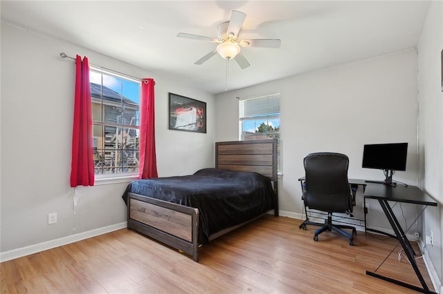 bedroom with ceiling fan and light wood-type flooring