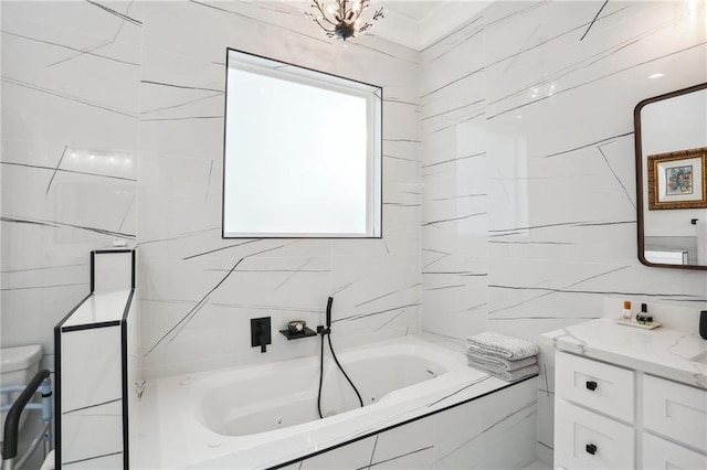 bathroom with vanity, a relaxing tiled tub, and tile walls