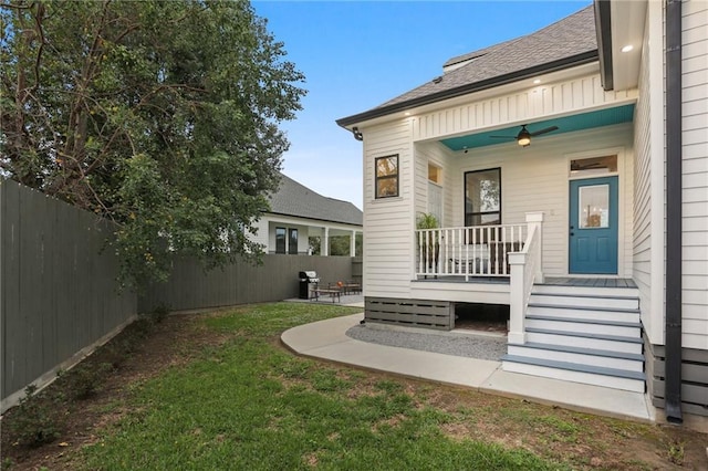 exterior space with a yard and ceiling fan