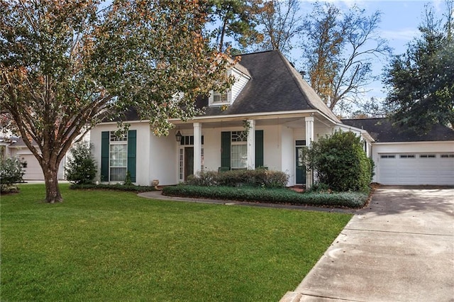 view of front of house with covered porch, a garage, and a front lawn