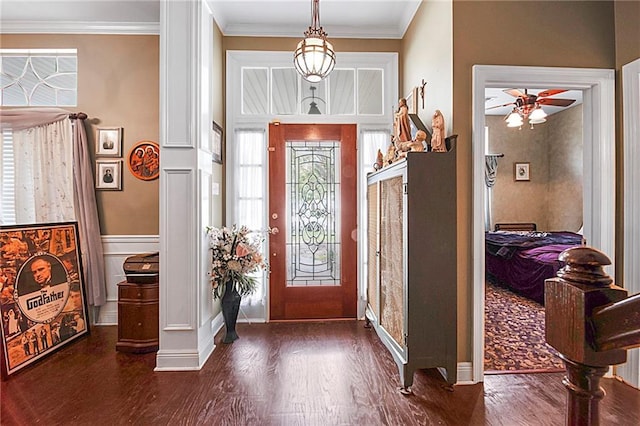 entryway with dark hardwood / wood-style floors, ceiling fan, and ornamental molding