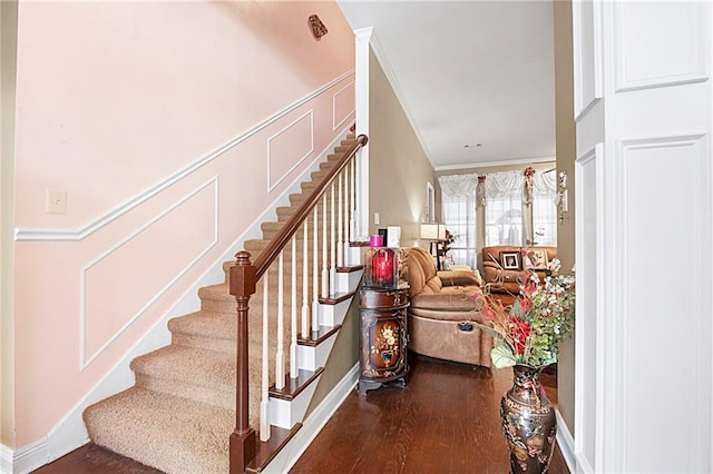 stairway featuring hardwood / wood-style floors and ornamental molding