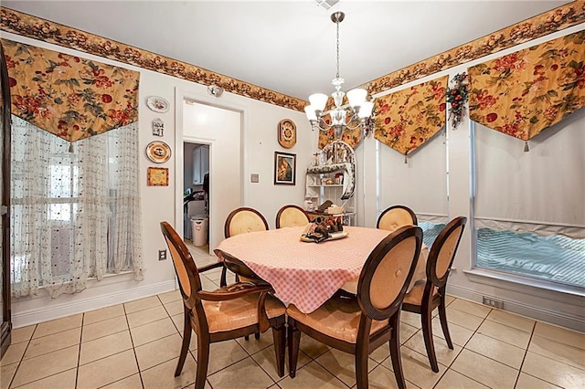 dining room with a notable chandelier and light tile patterned flooring