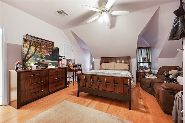 bedroom with ceiling fan, light wood-type flooring, and vaulted ceiling