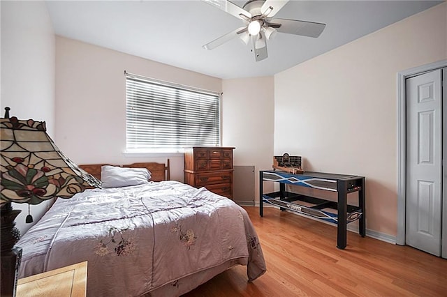 bedroom with ceiling fan and wood-type flooring