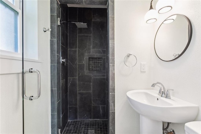 bathroom featuring sink, toilet, and walk in shower