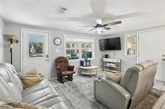 tiled living room featuring ceiling fan